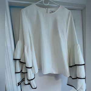 Ruffle sleeve top. White with black trim sleeves. NWT. Size Medium.